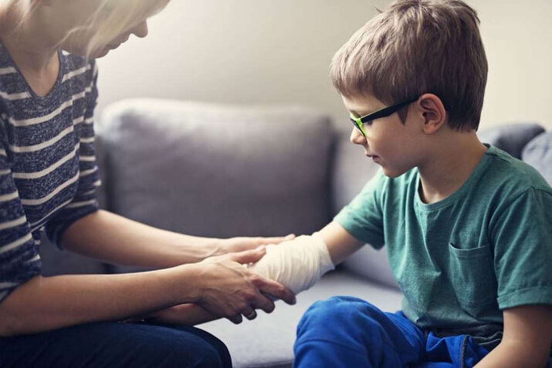 A person bandaging a child's hand

AI-generated content may be incorrect.